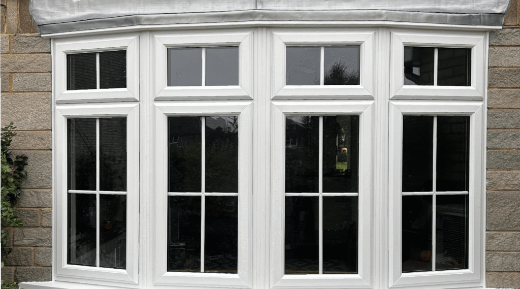 Installer measuring window frame before window replacement Oxford