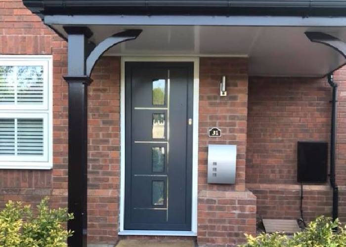 Modern home renovation with stylish white composite door with glass.
