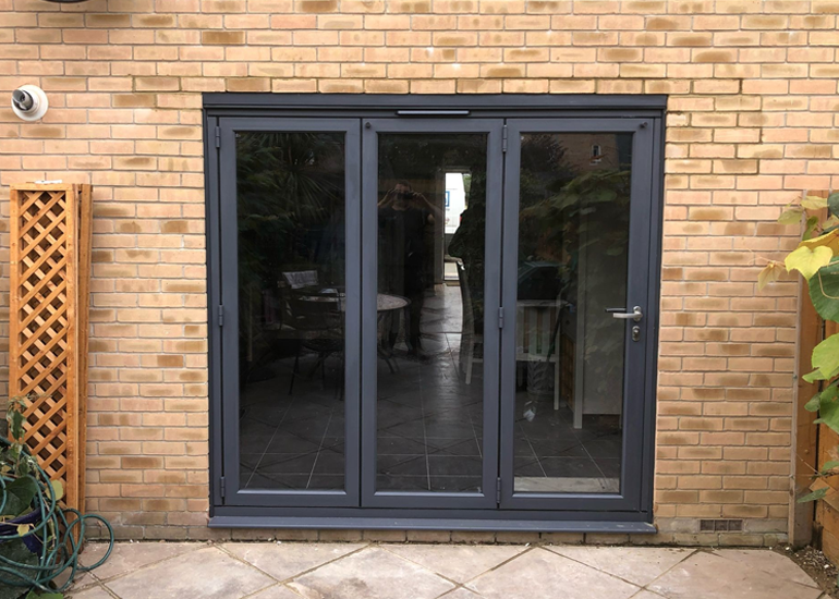 FENSA installers fitting bespoke French doors in a Bedford home.