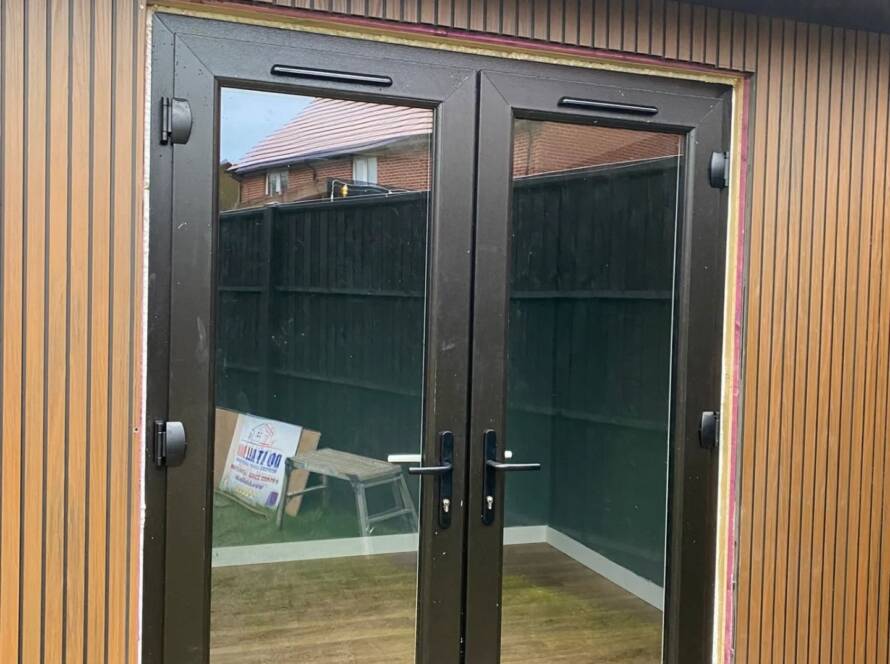 Aluminium French door installation in Bedfordshire garden.