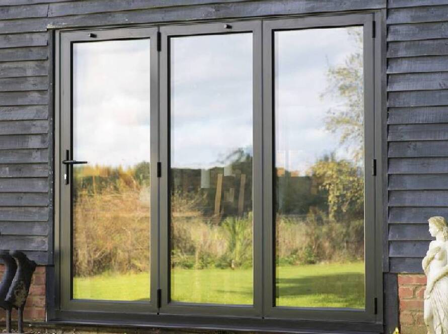 Homeowner cleaning bi-fold doors track for smooth sliding performance